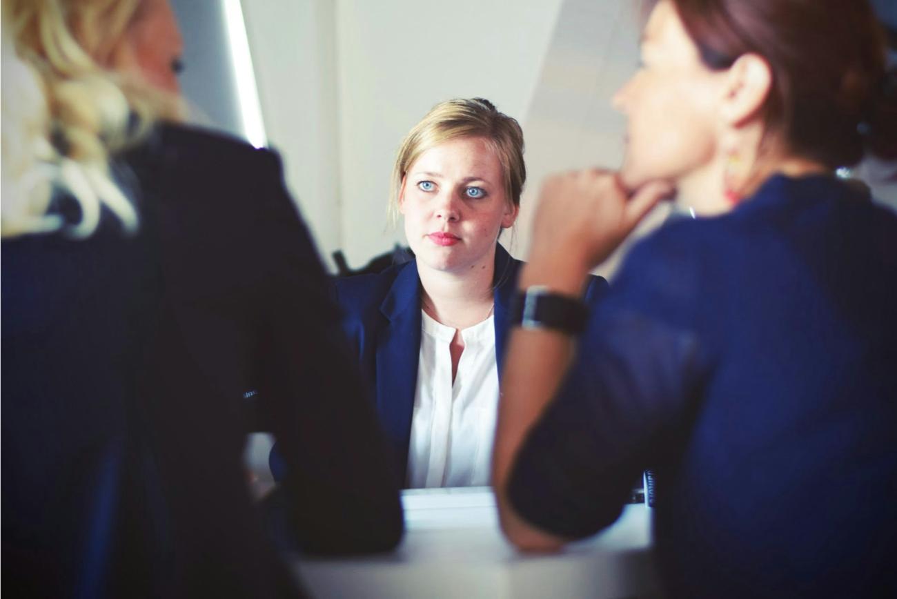 Woman listening intently to colleagues